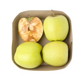 Photo of Spoiled apple and good ones in box isolated on white, top view