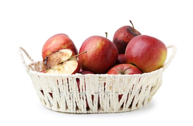 Photo of Spoiled apple and good ones in basket isolated on white
