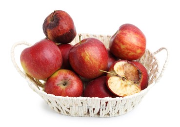 Photo of Spoiled apple and good ones in basket isolated on white