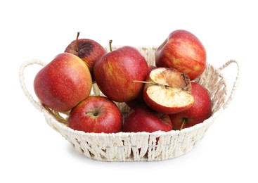 Photo of Spoiled apple and good ones in basket isolated on white