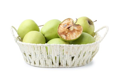 Photo of Spoiled apple and good ones in basket isolated on white