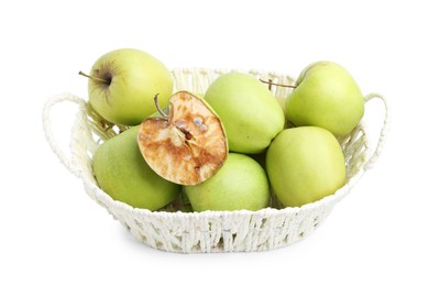 Photo of Spoiled apple and good ones in basket isolated on white