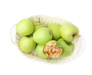 Photo of Spoiled apple and good ones in basket isolated on white, top view