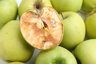 Photo of Spoiled apple and good ones on white background, closeup