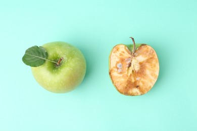 Photo of Spoiled apple and good ones on turquoise background, flat lay