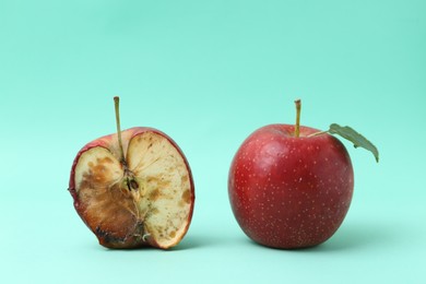 Photo of Spoiled apple and good ones on turquoise background