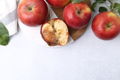 Photo of Spoiled apple and good ones on white table, flat lay. Space for text