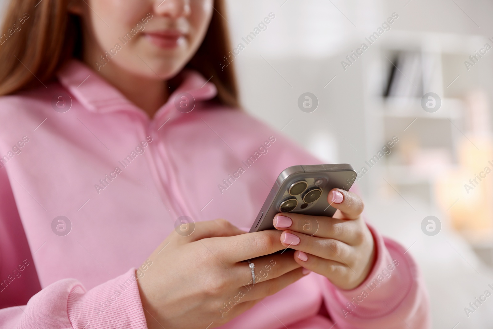 Teenage girl using smartphone at home, closeup Photo of Teenage girl using smartphone at home, closeup