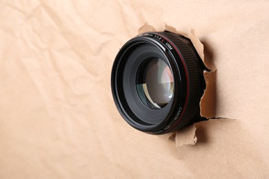Photo of Hidden camera lens through hole in paper, closeup