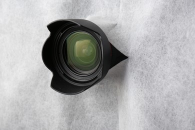 Photo of Hidden camera lens through torn hole in white fabric