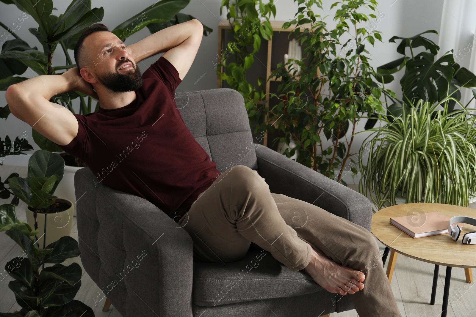 Harmony. Man relaxing in comfortable armchair at home Photo of Harmony. Man relaxing in comfortable armchair at home