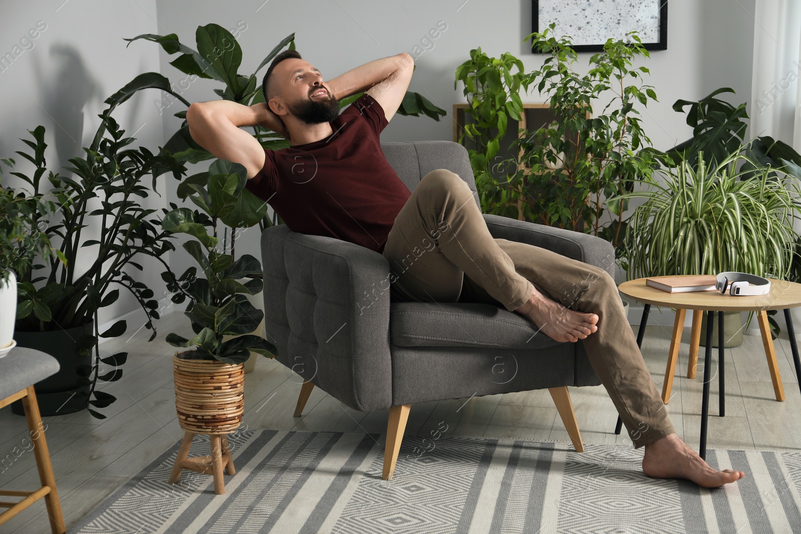 Harmony. Man relaxing in comfortable armchair at home Photo of Harmony. Man relaxing in comfortable armchair at home