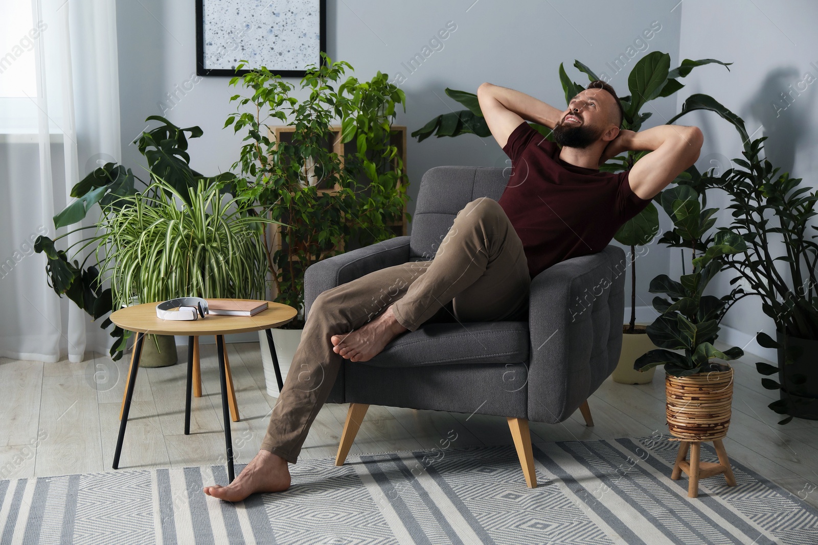 Harmony. Man relaxing in comfortable armchair at home Photo of Harmony. Man relaxing in comfortable armchair at home