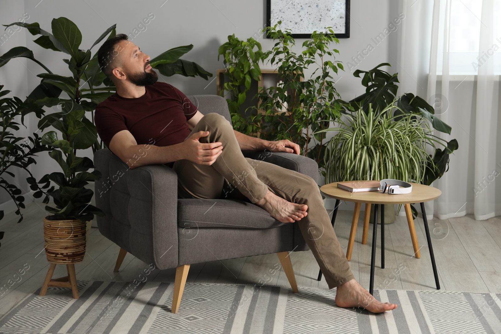 Harmony. Man relaxing in comfortable armchair at home Photo of Harmony. Man relaxing in comfortable armchair at home