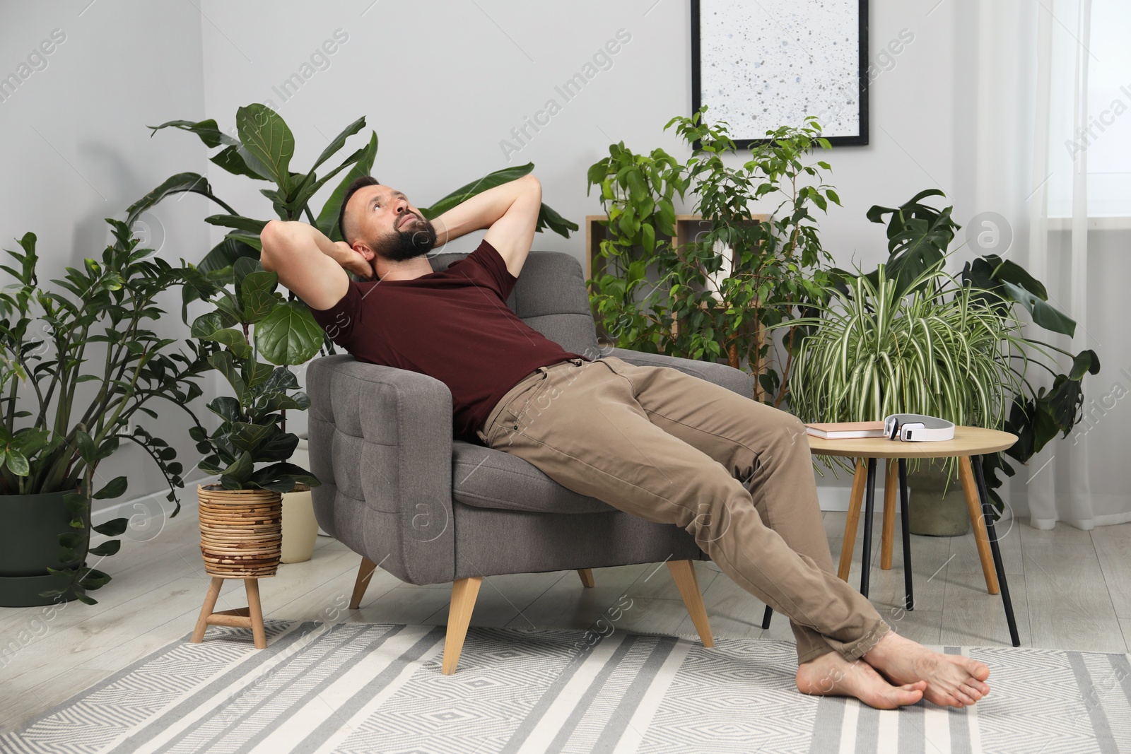 Harmony. Man relaxing in comfortable armchair at home Photo of Harmony. Man relaxing in comfortable armchair at home