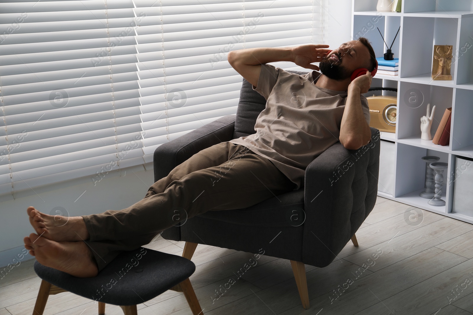 Photo of Harmony. Man listening to music in headphones at home
