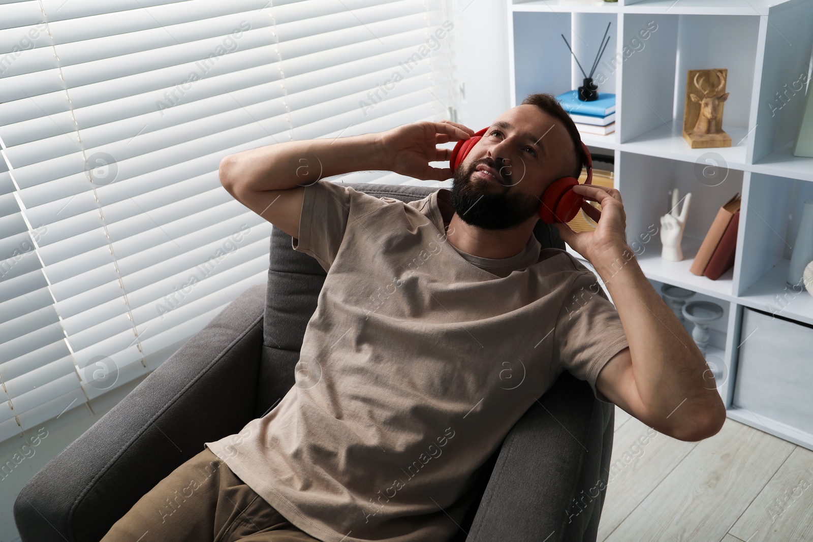 Harmony. Man listening to music in headphones at home Photo of Harmony. Man listening to music in headphones at home