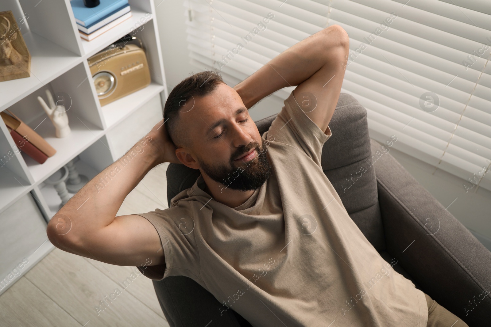 Harmony. Man relaxing in comfortable armchair at home, above view Photo of Harmony. Man relaxing in comfortable armchair at home, above view