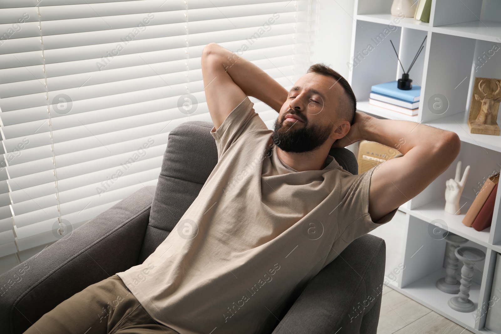 Harmony. Man relaxing in comfortable armchair at home Photo of Harmony. Man relaxing in comfortable armchair at home