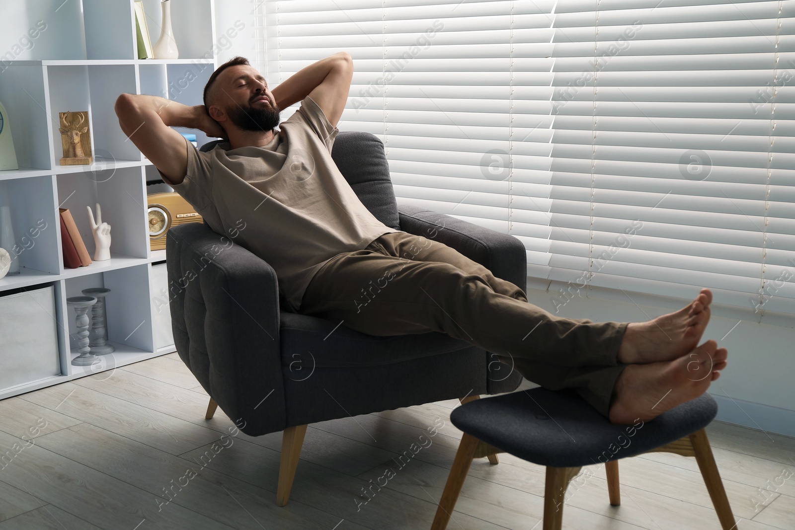 Harmony. Man relaxing in comfortable armchair at home Photo of Harmony. Man relaxing in comfortable armchair at home