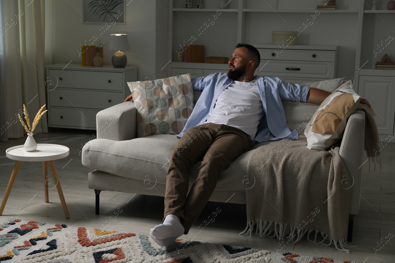 Harmony. Man relaxing on comfortable sofa at home Photo of Harmony. Man relaxing on comfortable sofa at home