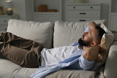 Photo of Harmony. Man relaxing on comfortable sofa at home