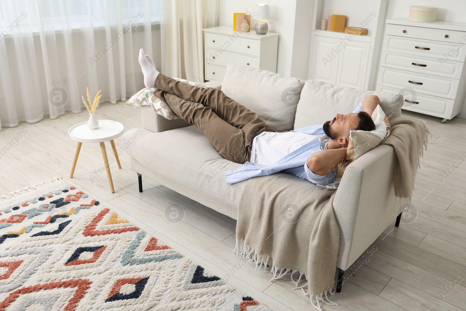 Harmony. Man relaxing on comfortable sofa at home Photo of Harmony. Man relaxing on comfortable sofa at home