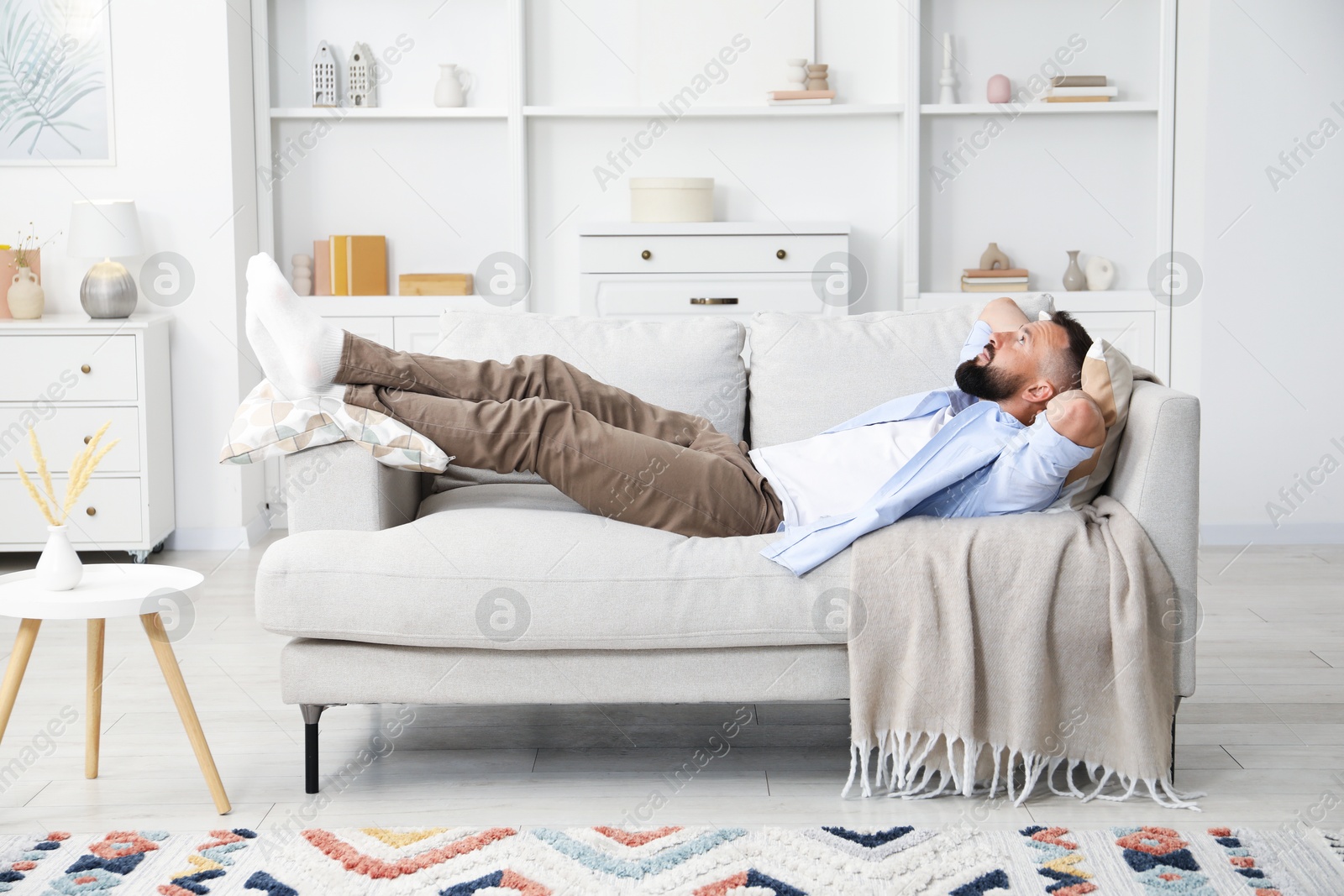 Harmony. Man relaxing on comfortable sofa at home Photo of Harmony. Man relaxing on comfortable sofa at home