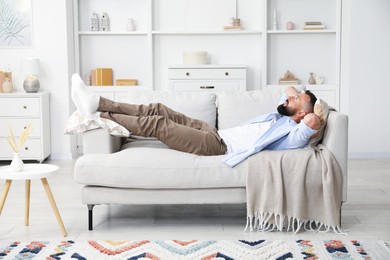 Photo of Harmony. Man relaxing on comfortable sofa at home