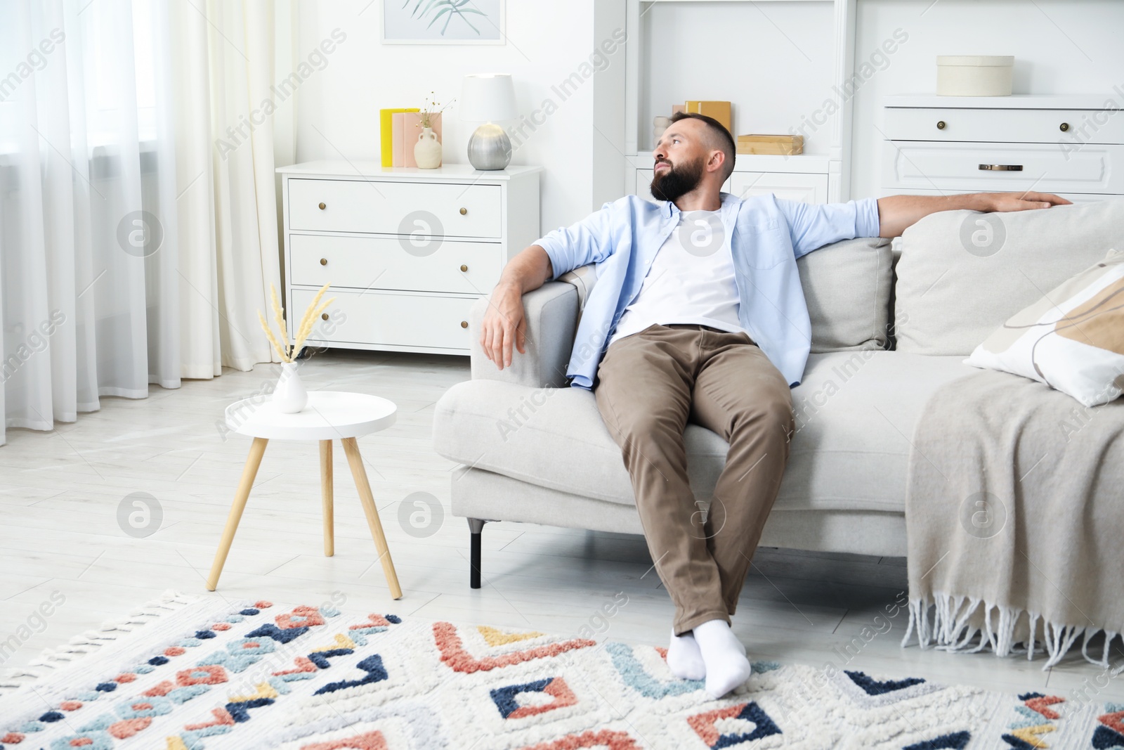 Harmony. Man relaxing on comfortable sofa at home Photo of Harmony. Man relaxing on comfortable sofa at home