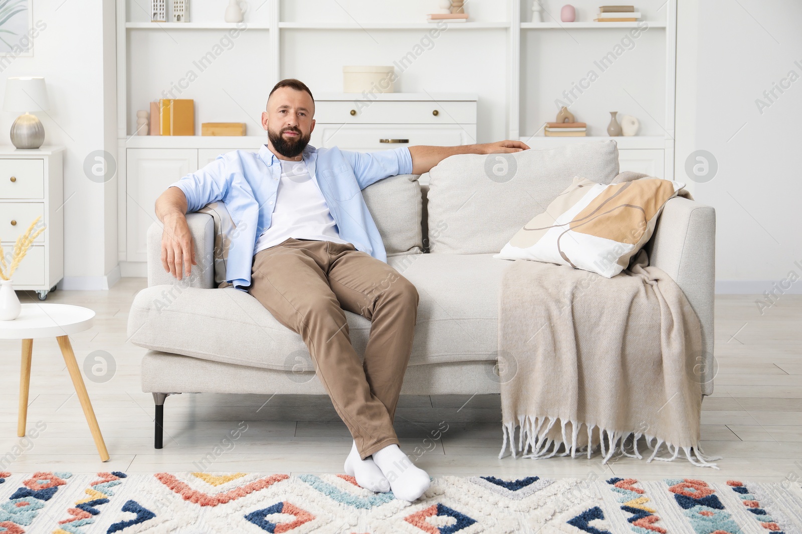 Harmony. Man relaxing on comfortable sofa at home Photo of Harmony. Man relaxing on comfortable sofa at home