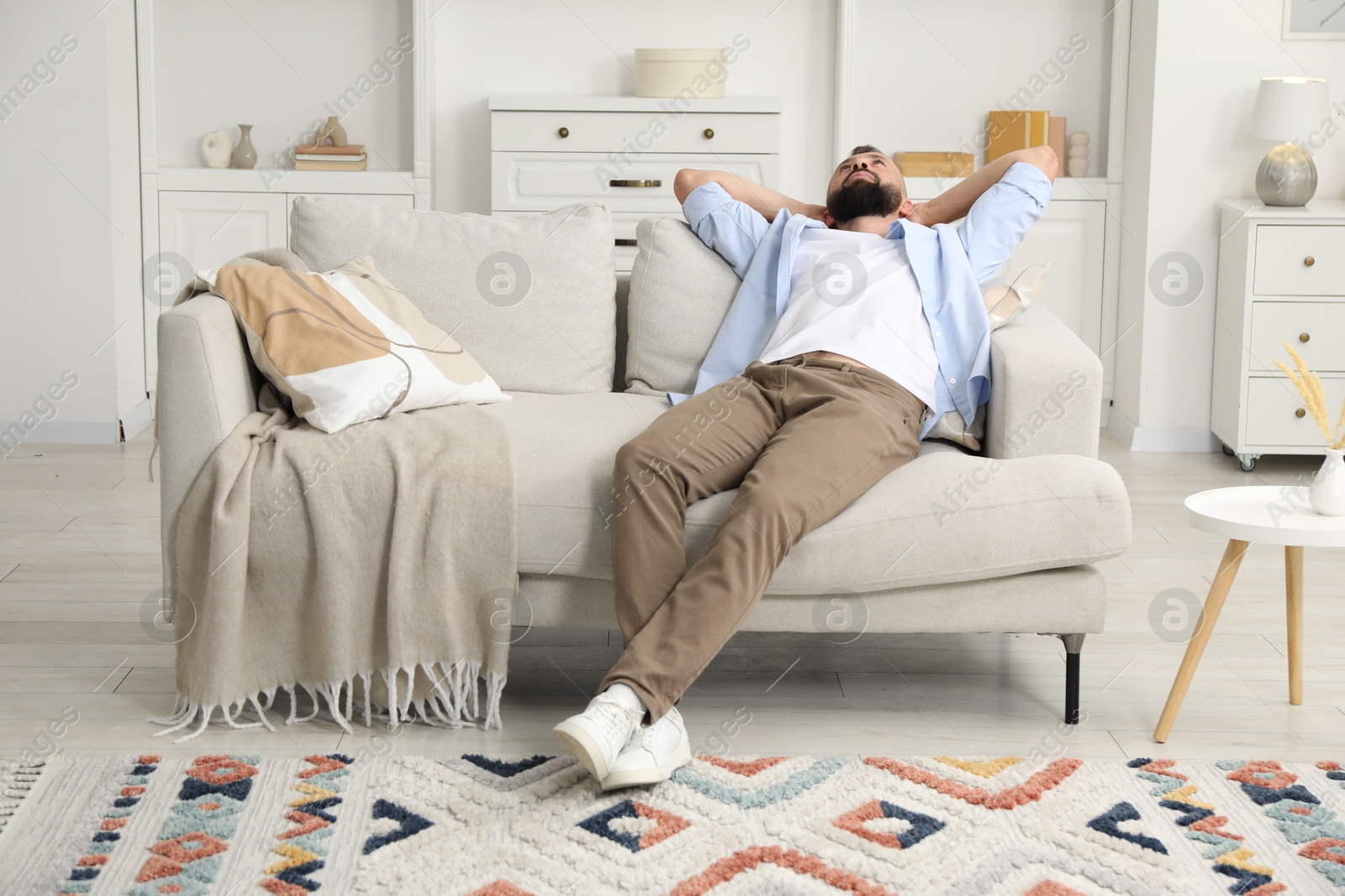 Harmony. Man relaxing on comfortable sofa at home Photo of Harmony. Man relaxing on comfortable sofa at home