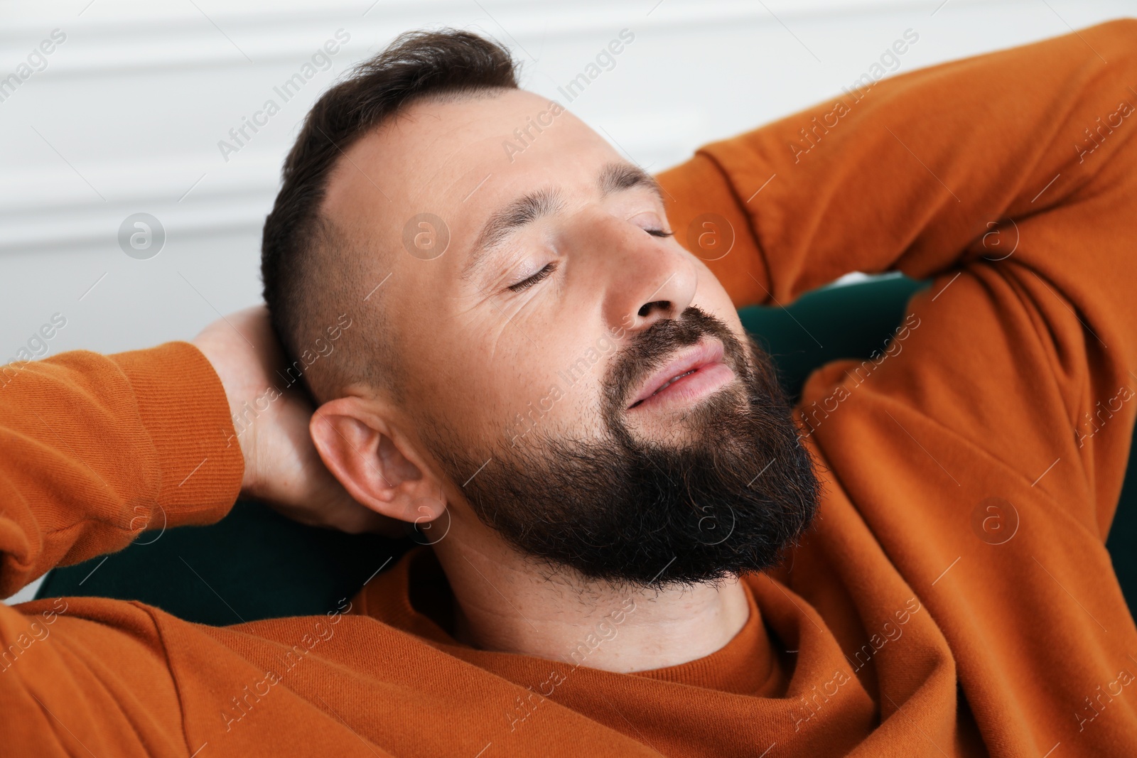 Harmony. Man relaxing in comfortable armchair at home, closeup Photo of Harmony. Man relaxing in comfortable armchair at home, closeup