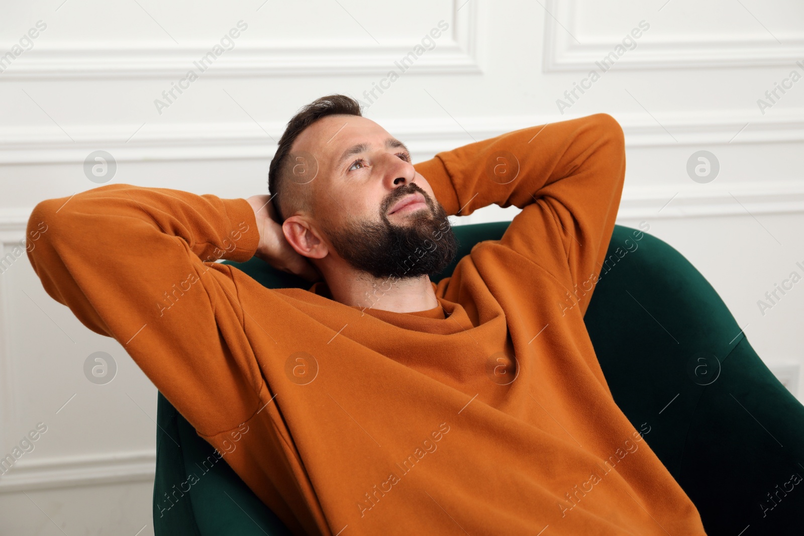 Harmony. Man relaxing in comfortable armchair at home Photo of Harmony. Man relaxing in comfortable armchair at home