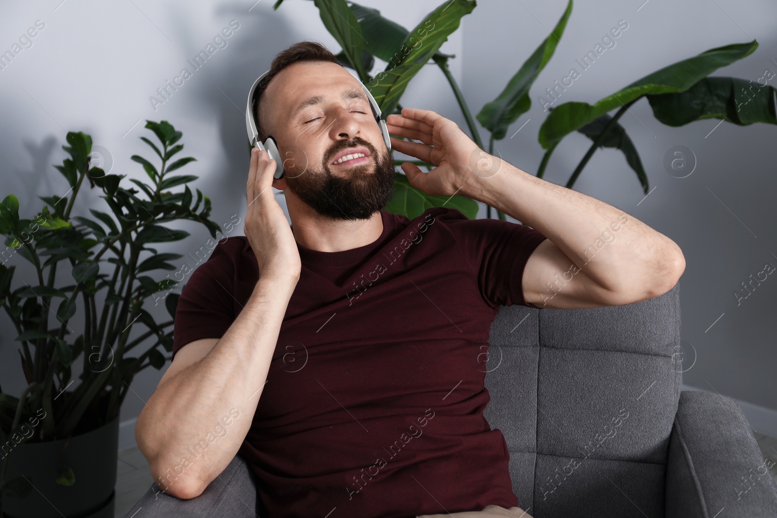 Photo of Harmony. Man listening to music in headphones at home