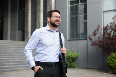 Photo of Portrait of successful businessman near office building