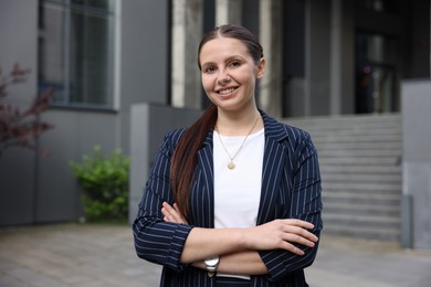 Photo of Portrait of successful businesswoman near office building