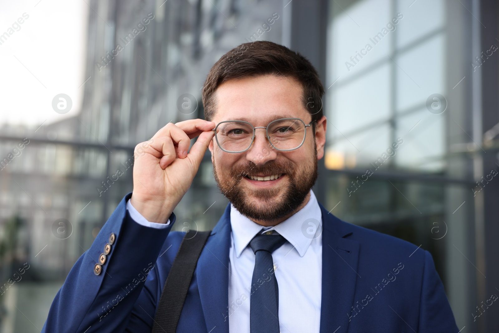 Photo of Portrait of successful businessman near office building