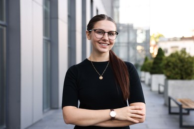 Photo of Portrait of successful businesswoman near office building