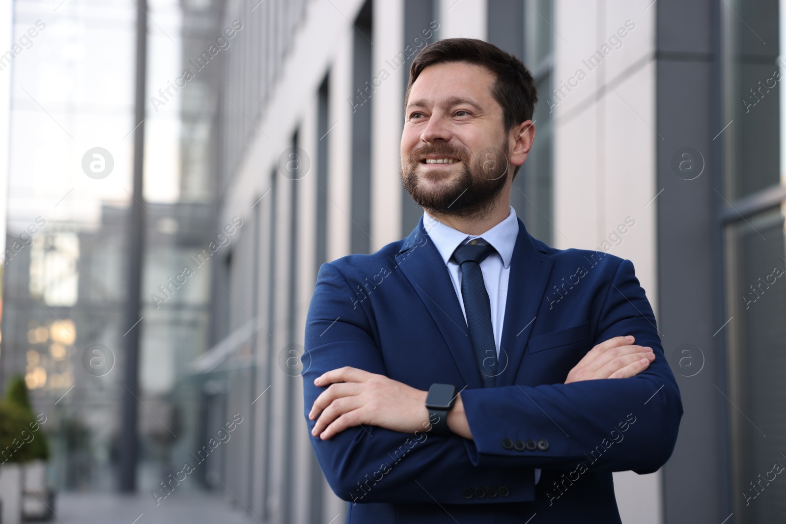 Portrait of successful businessman near office building. Space for text Photo of Portrait of successful businessman near office building. Space for text
