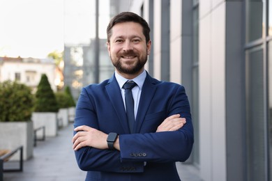 Photo of Portrait of successful businessman near office building