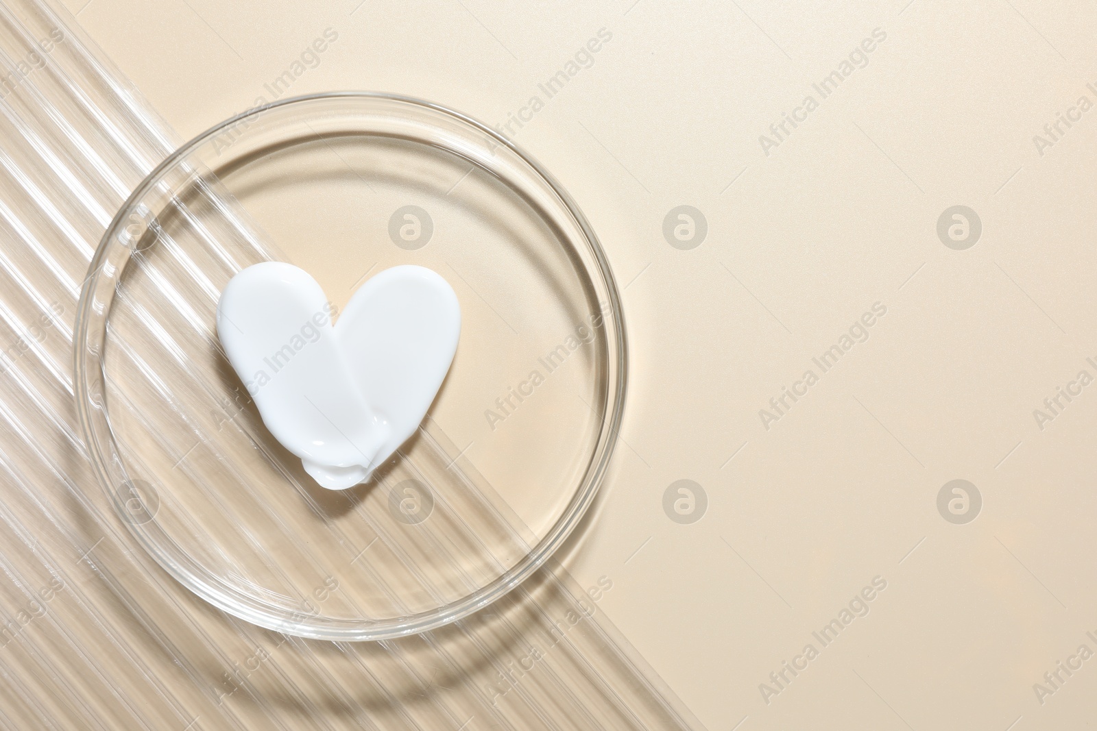 Cosmetic product in Petri dish on beige background, top view. Space for text Photo of Cosmetic product in Petri dish on beige background, top view. Space for text