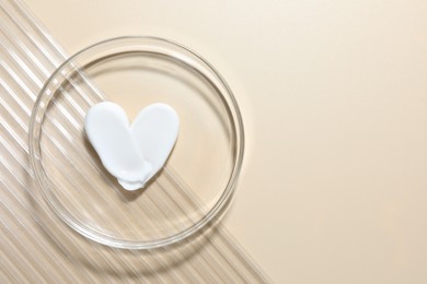 Photo of Cosmetic product in Petri dish on beige background, top view. Space for text