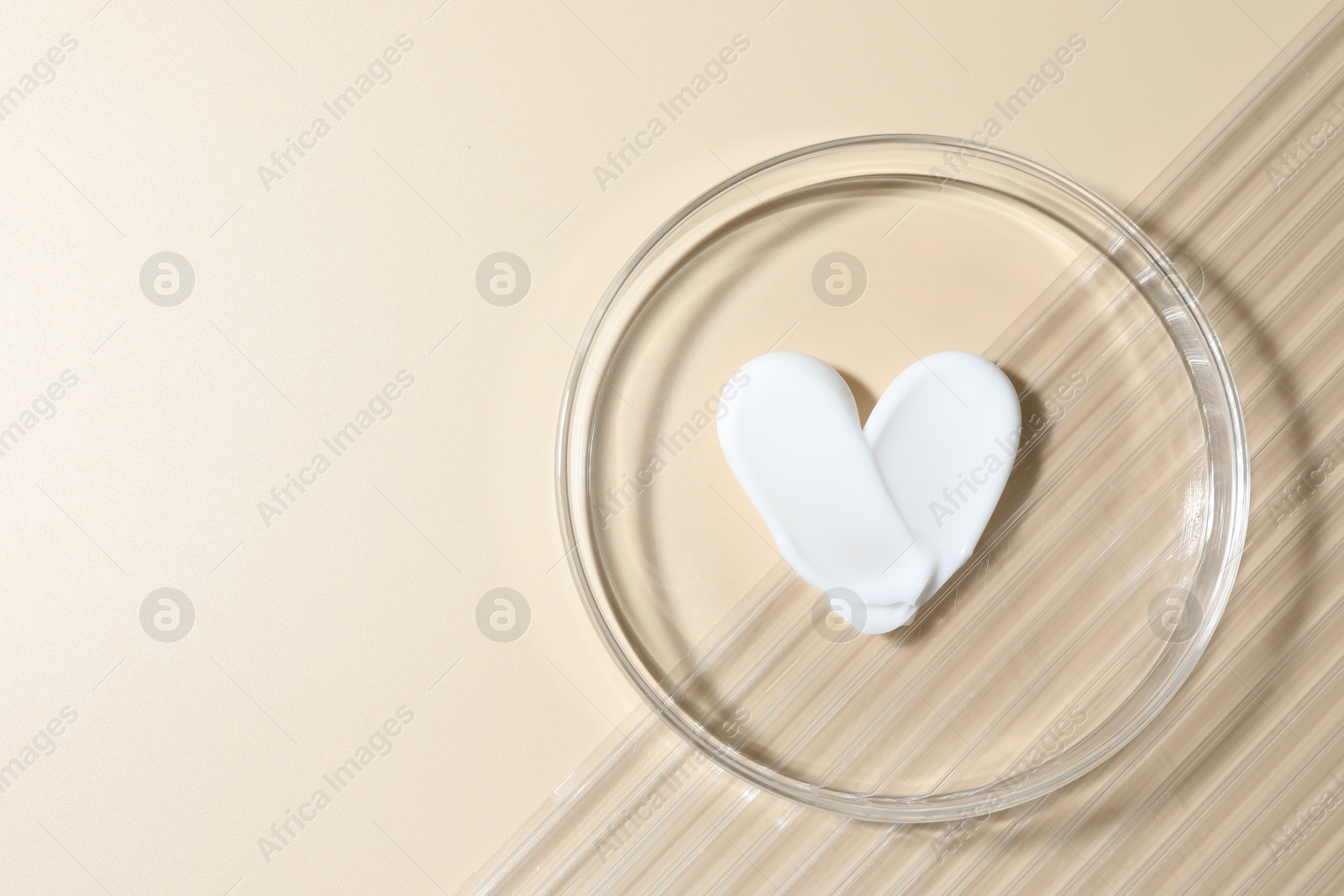Cosmetic product in Petri dish on beige background, top view. Space for text Photo of Cosmetic product in Petri dish on beige background, top view. Space for text