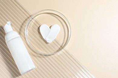 Photo of Cosmetic product in Petri dish and bottle on beige background, top view. Space for text