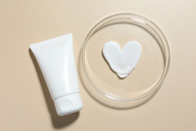 Photo of Cosmetic product in Petri dish and tube on beige background, flat lay