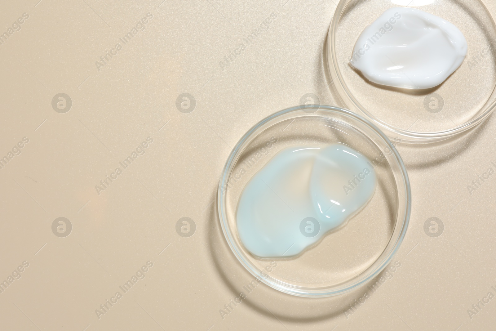 Different cosmetic products in Petri dishes on beige background, flat lay. Space for text Photo of Different cosmetic products in Petri dishes on beige background, flat lay. Space for text