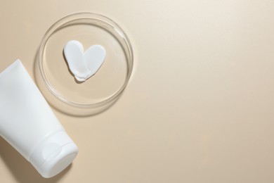 Photo of Cosmetic product in Petri dish and tube on beige background, flat lay. Space for text