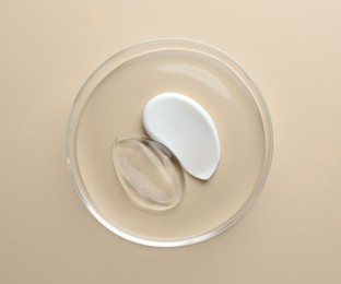 Photo of Different cosmetic products in Petri dish on beige background, top view
