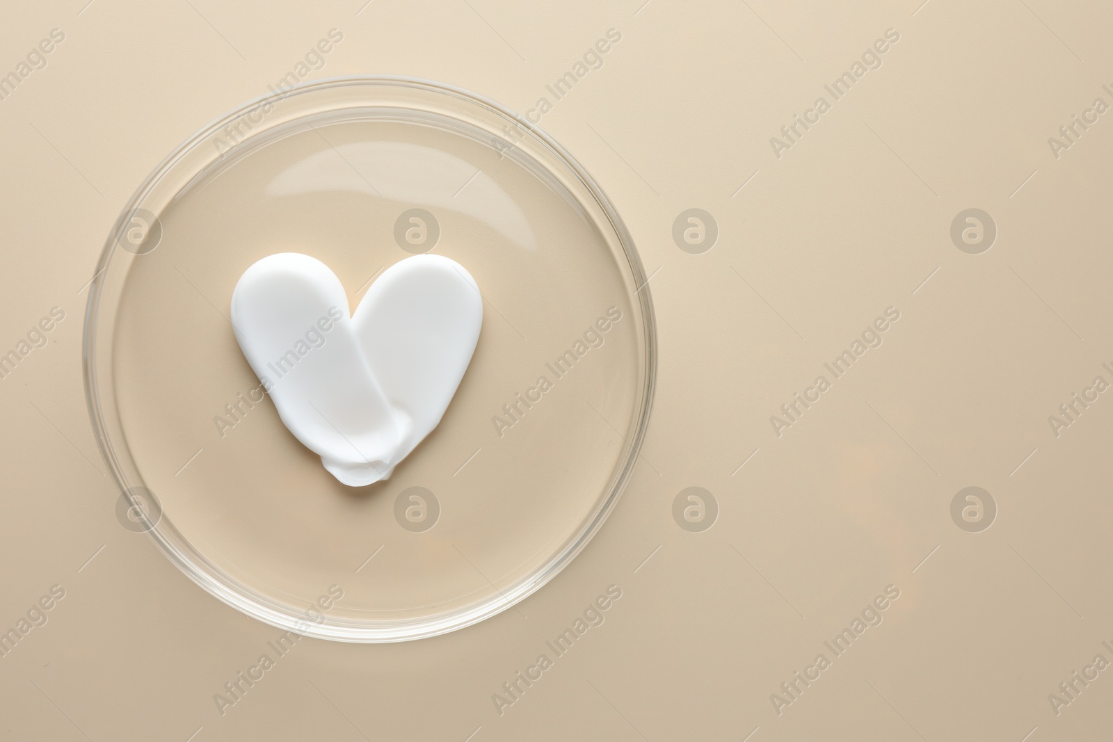 Cosmetic product in Petri dish on beige background, top view. Space for text Photo of Cosmetic product in Petri dish on beige background, top view. Space for text